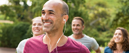 Man smiling and walking with a group of friends