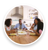 Family enjoying the conversation around the dinner table.