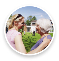 Grandmother and daughter with arms around each other.