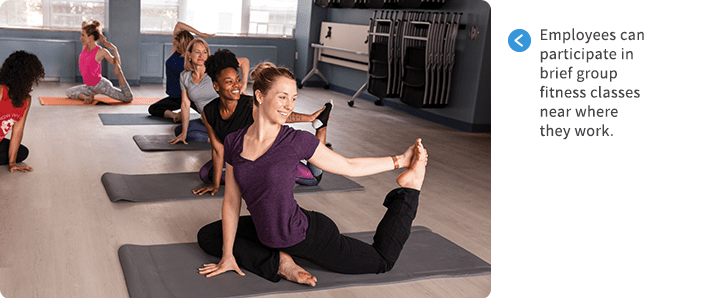 Employees participating in a yoga class