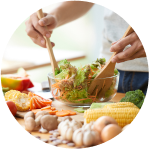 Person making a salad with fresh produce